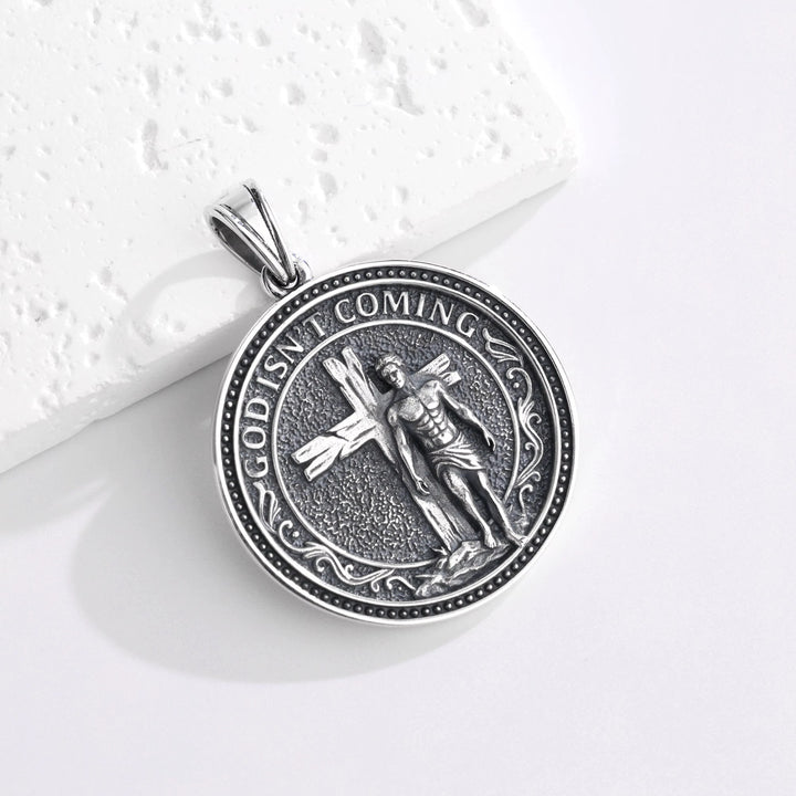 BLACK CLAW SELF-LIBERATION PENDANT 表面 GOD ISN'T COMING 十字架から歩き出す青年の立体彫刻